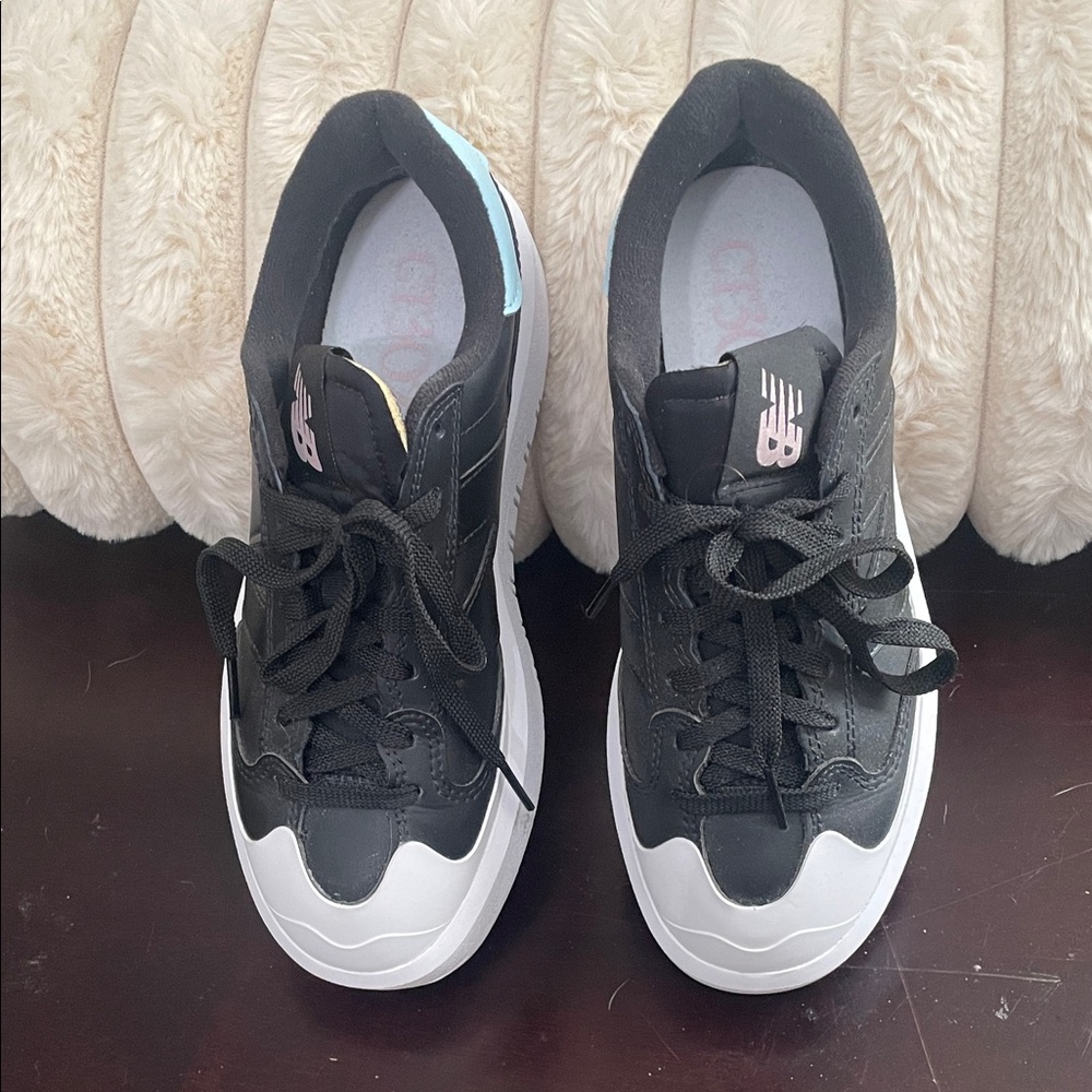 New Balance Black Sneakers with White Soles and Pastel Pink & Light Blue Accents
